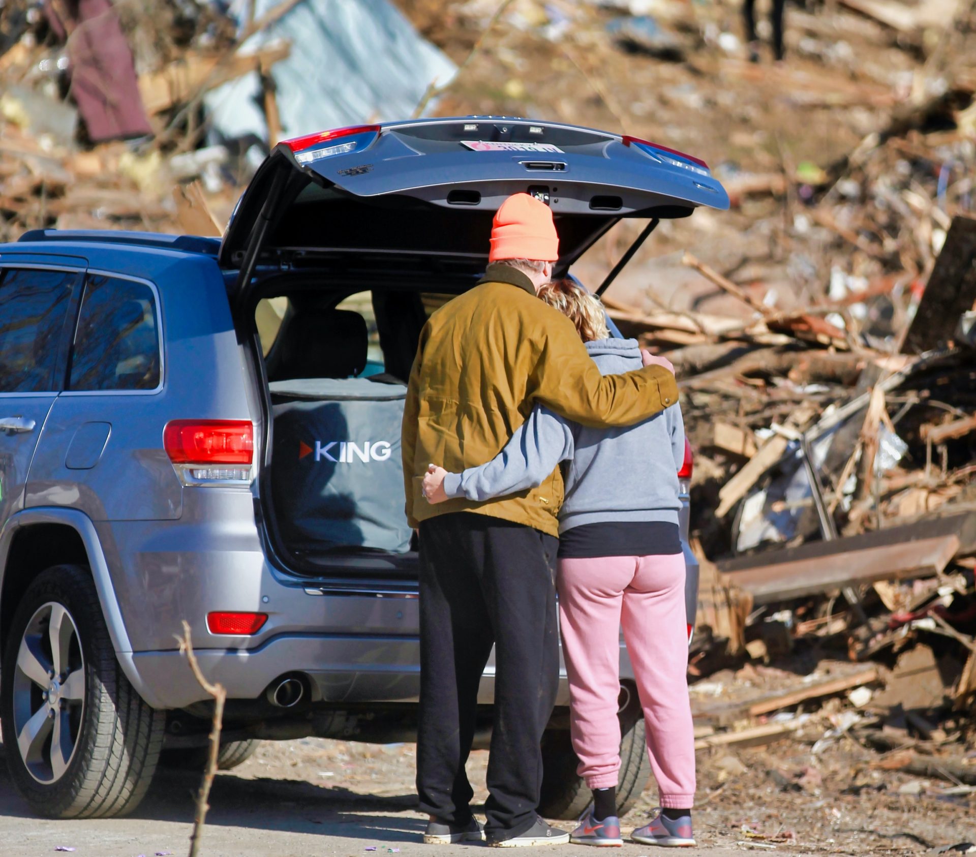 couple waiting for natural disaster relief after emergency